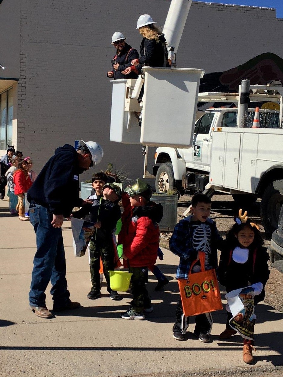 Coop giving out candy at Halloween Parade